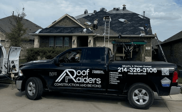 Roof Raiders branded crew truck on a residential DFW job site